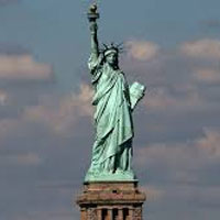 Statue of Liberty against a cloudy sky.